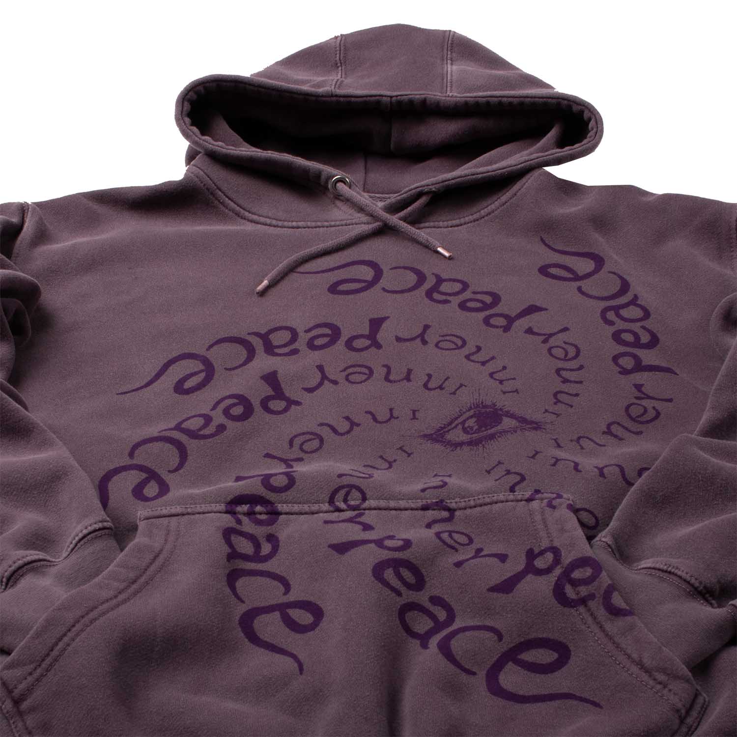 Closeup detail angled photo showing hood. Also the many repetitions of "Inner Peace" text circling an "all seeing eye". Altru Inner Peace Dark Purple Hoodie. Garment dyed and washed for soft vintage look and feel,