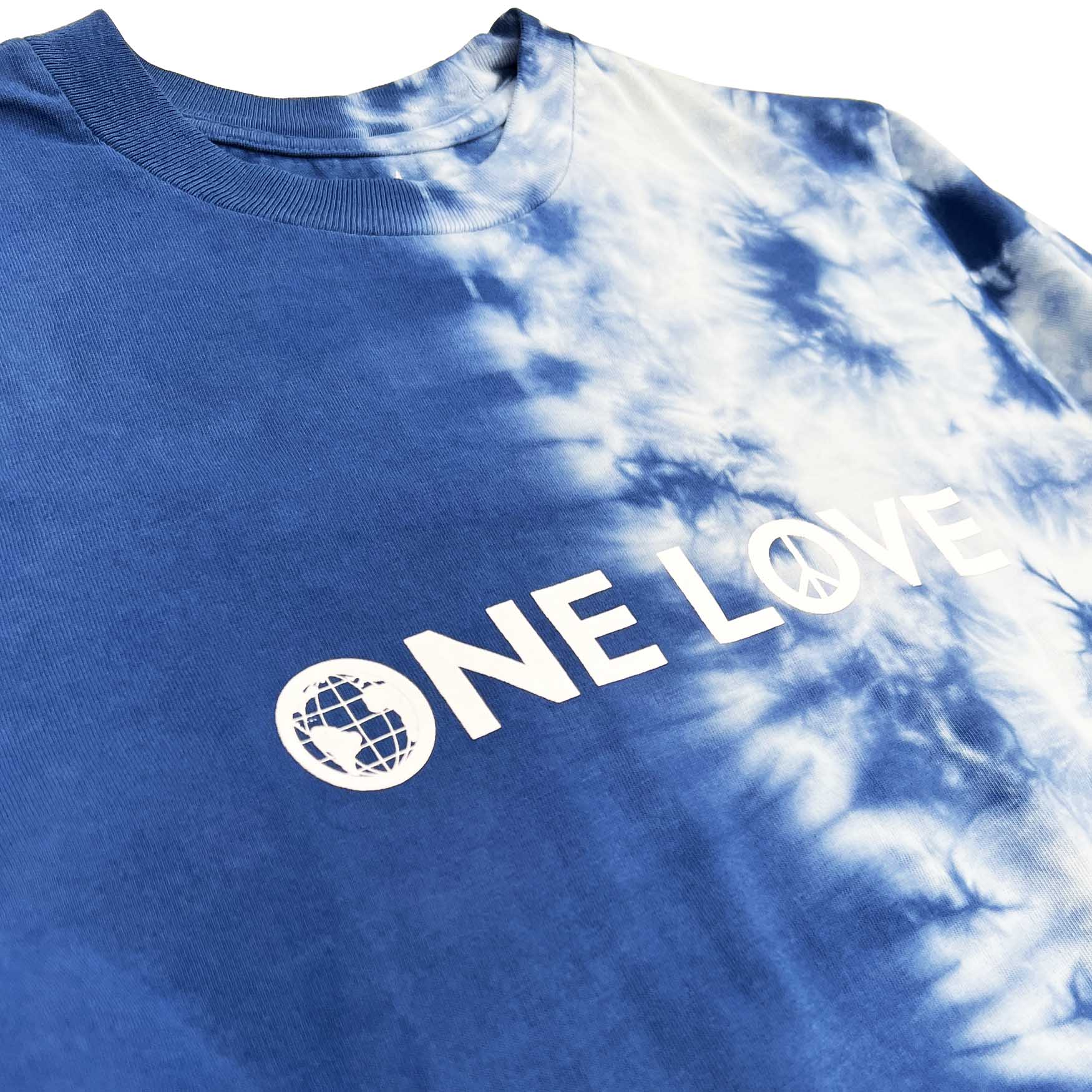 Altru One Love high-density print on half tie dye t-shirt. Front image close up print.