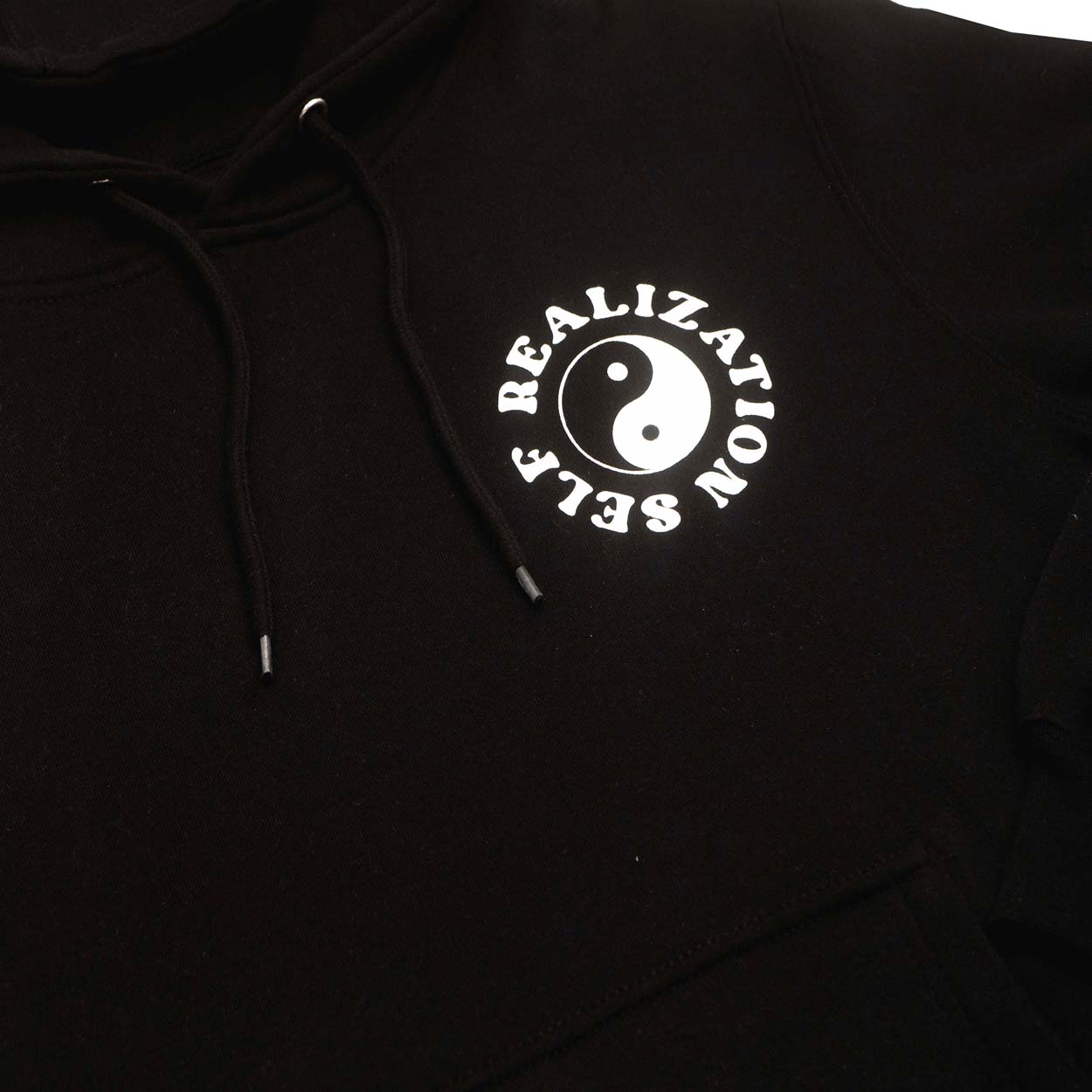 men's graphic black fleece hoodie with yin yang symbols , yoga positions and mental health positive text printed on front and back. Detail front photo.