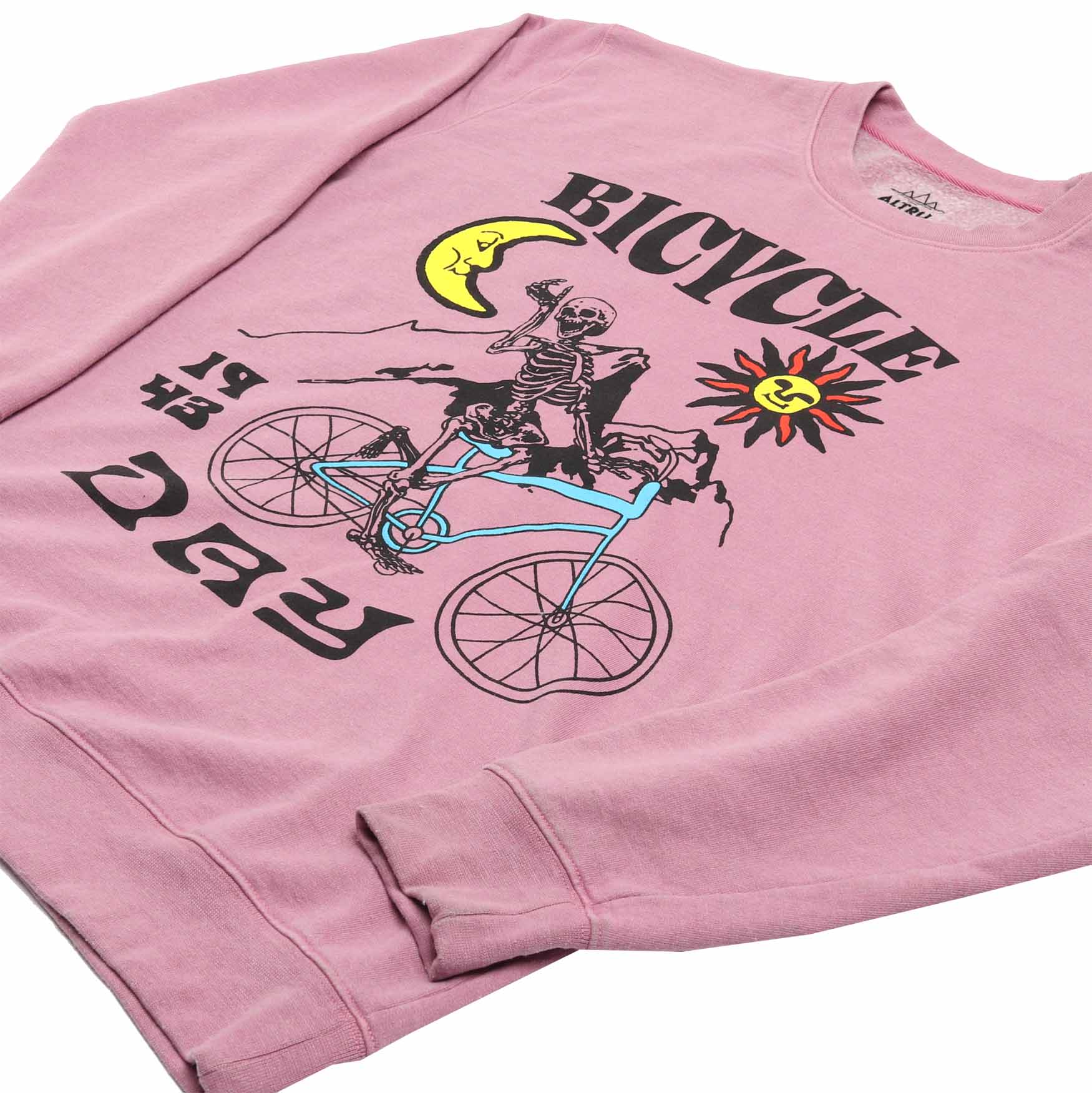 up close detail 2 of Altru mens pink fleece sweatshirt with a skeleton riding a bicycle graphic on front and the text "If the doors of perception were cleansed every thing would appear to man as it is, infinite."  printed on the back.